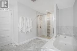 Primary Ensuite with Tiled Shower and Soaker Tub - 