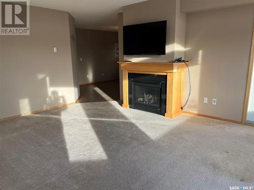 202 1225 Stockton Street N, Regina, SK - Indoor Photo Showing Living Room With Fireplace