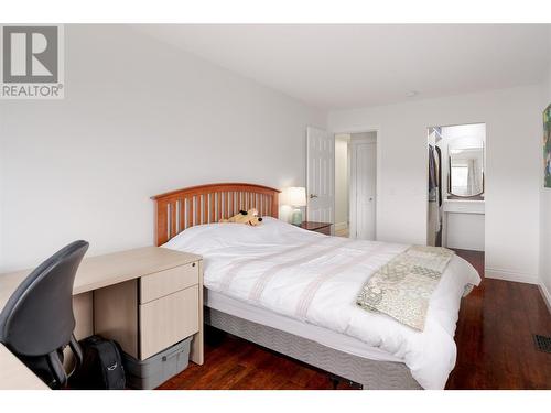 Bed #2 with a walk in closet featuring custom cabinetry - 600 Welke Road, Kelowna, BC - Indoor Photo Showing Bedroom