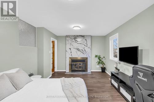 700 Levac Drive, Ottawa, ON - Indoor Photo Showing Bedroom With Fireplace