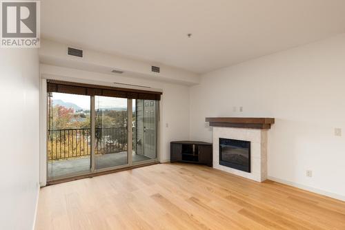 2142 Vasile Road Road Unit# 313, Kelowna, BC - Indoor Photo Showing Living Room With Fireplace