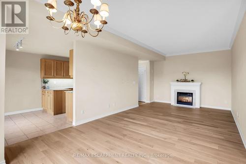 807 - 3000 Creekside Drive, Hamilton, ON - Indoor Photo Showing Other Room With Fireplace