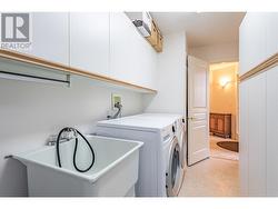 Spacious laundry room with sink and lots of storage space - 