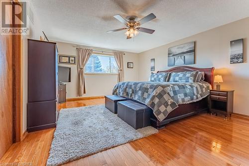 Bedroom with light hardwood / wood-style floors, a textured ceiling, and ceiling fan - 2080 Sixth Line, Oakville, ON - Indoor Photo Showing Bedroom