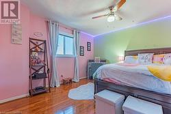 Bedroom featuring hardwood / wood-style floors, ceiling fan, and a textured ceiling - 