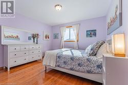 Bedroom featuring light hardwood / wood-style floors - 