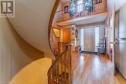 Entryway featuring light wood-type flooring and a towering ceiling - 