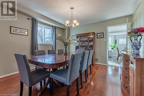 Dining area with hardwood / wood-style flooring, a chandelier, and a textured ceiling - 2080 Sixth Line, Oakville, ON - Indoor Photo Showing Dining Room