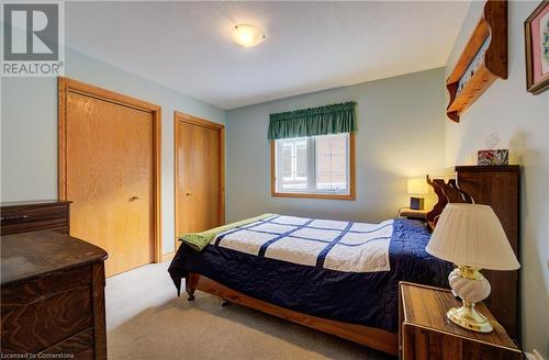 Carpeted bedroom with two closets - 42 River Run Road, Drayton, ON - Indoor Photo Showing Bedroom