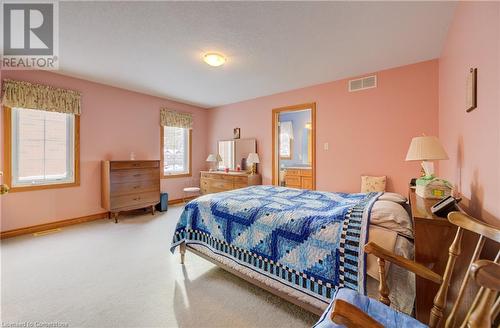 Carpeted bedroom featuring connected bathroom - 42 River Run Road, Drayton, ON - Indoor Photo Showing Bedroom