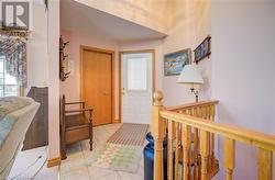 Foyer with light tile patterned floors and a healthy amount of sunlight - 