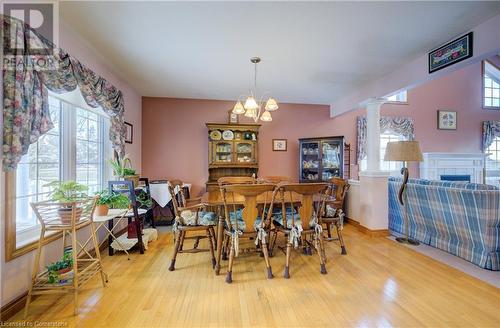 Dining area with a healthy amount of sunlight, decorative columns, light hardwood floors - 42 River Run Road, Drayton, ON - Indoor Photo Showing Dining Room