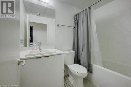 Full bathroom with tile patterned flooring, vanity, toilet, and shower / bathtub combination with curtain - 55 Duke Street Unit# 322, Kitchener, ON - Indoor Photo Showing Bathroom