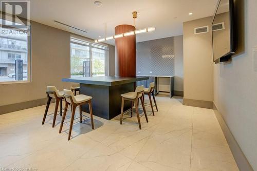 Kitchen with decorative light fixtures and a breakfast bar area - 55 Duke Street Unit# 322, Kitchener, ON - Indoor Photo Showing Dining Room