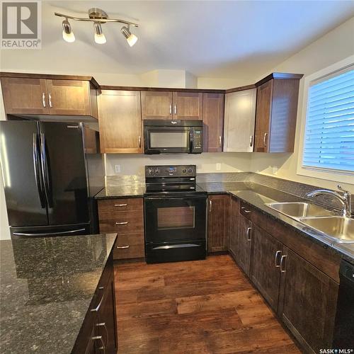 103 3440 Avonhurst Drive, Regina, SK - Indoor Photo Showing Kitchen With Double Sink