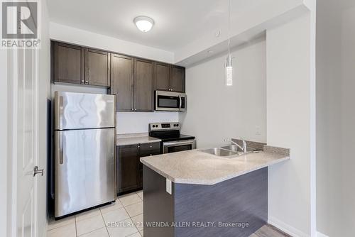 211 - 84 Aspen Springs Drive, Clarington, ON - Indoor Photo Showing Kitchen With Stainless Steel Kitchen With Double Sink