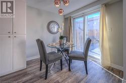 Dining area with dark hardwood / wood-style flooring - 