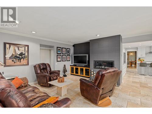 Living room off kitchen - 761 Siwash Court, Kelowna, BC - Indoor Photo Showing Living Room With Fireplace