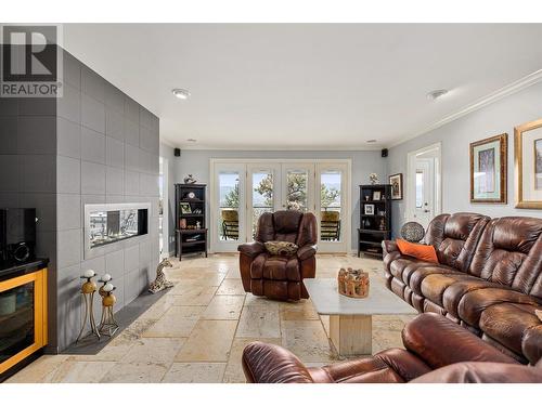 Living room off kitchen - 761 Siwash Court, Kelowna, BC - Indoor Photo Showing Living Room With Fireplace