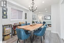 Dining room with a chandelier and light wood-type flooring - 