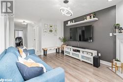 Living room with a chandelier and light hardwood / wood-style flooring - 