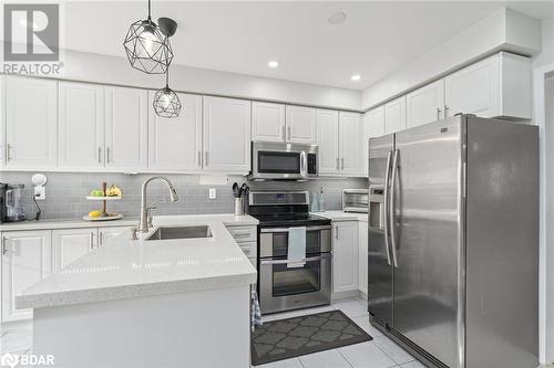 Kitchen featuring appliances with stainless steel finishes, decorative light fixtures, white cabinetry, and sink - 50 Smith Drive, Georgetown, ON - Indoor Photo Showing Kitchen With Upgraded Kitchen