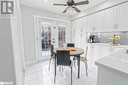 Dining area featuring ceiling fan, french doors, and light tile patterned flooring - 