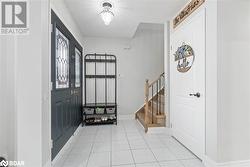 Foyer featuring light tile patterned floors - 