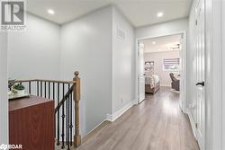 Hallway with light wood-type flooring - 