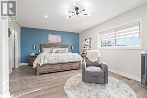 Bedroom with hardwood / wood-style floors and a notable chandelier - 50 Smith Drive, Georgetown, ON - Indoor Photo Showing Bedroom