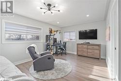 Living room featuring a chandelier and light hardwood / wood-style floors - 