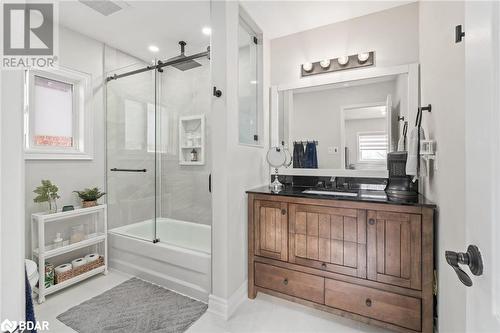 Bathroom featuring tile patterned flooring, vanity, and bath / shower combo with glass door - 50 Smith Drive, Georgetown, ON - Indoor Photo Showing Bathroom