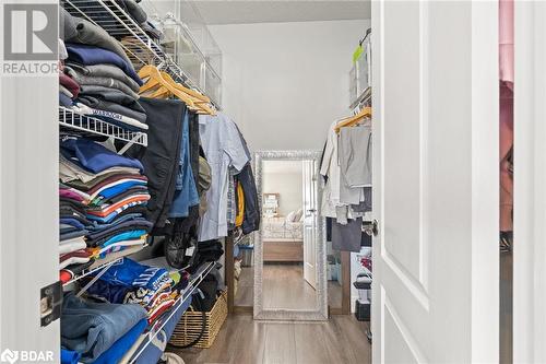 Walk in closet featuring wood-type flooring - 50 Smith Drive, Georgetown, ON - Indoor With Storage