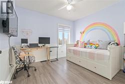 Bedroom with light hardwood / wood-style flooring and ceiling fan - 