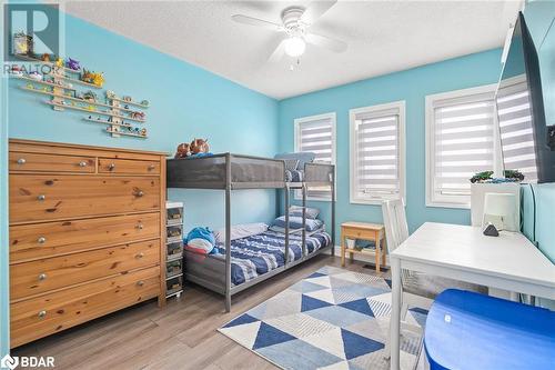 Bedroom featuring a textured ceiling, light hardwood / wood-style floors, and ceiling fan - 50 Smith Drive, Georgetown, ON - Indoor Photo Showing Bedroom