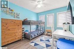 Bedroom featuring a textured ceiling, light hardwood / wood-style floors, and ceiling fan - 