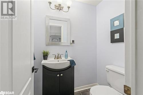 Bathroom with tile patterned flooring, vanity, an inviting chandelier, and toilet - 50 Smith Drive, Georgetown, ON - Indoor Photo Showing Bathroom