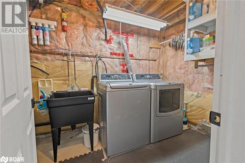 Clothes washing area with washing machine and clothes dryer and sink - 50 Smith Drive, Georgetown, ON - Indoor Photo Showing Laundry Room