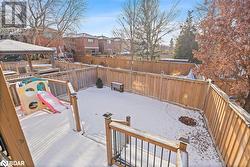 Snow covered deck featuring a gazebo and a playground - 