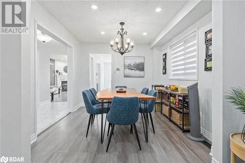 Dining area featuring a textured ceiling and an inviting chandelier - 50 Smith Drive, Georgetown, ON - Indoor Photo Showing Dining Room