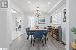 Dining area featuring a textured ceiling and an inviting chandelier - 