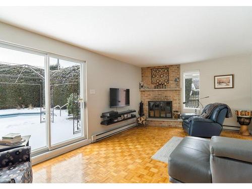 Family room - 2604 Rue De Vigny, Mascouche, QC - Indoor Photo Showing Living Room With Fireplace