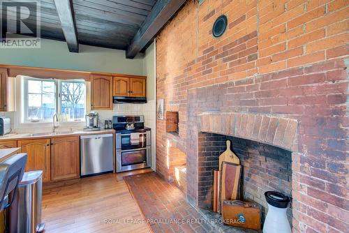 2555 County Road 38, Kingston (City North Of 401), ON - Indoor Photo Showing Kitchen With Fireplace With Double Sink