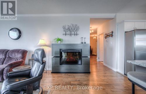 901 - 60 Wyndham Street S, Guelph, ON - Indoor Photo Showing Living Room With Fireplace