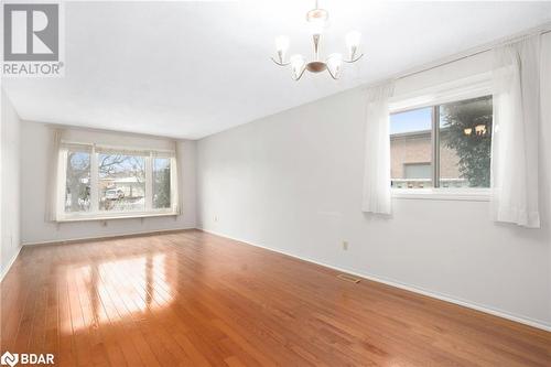 Spare room with a chandelier and hardwood / wood-style floors - 15 Oakington Place, Mississauga, ON - Indoor Photo Showing Other Room