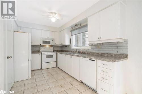 Kitchen with ceiling fan, sink, light tile patterned flooring, white appliances, and white cabinets - 15 Oakington Place, Mississauga, ON - Indoor Photo Showing Kitchen