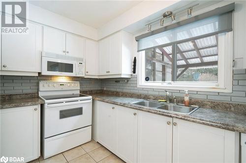 Kitchen with white cabinets, white appliances, and sink - 15 Oakington Place, Mississauga, ON - Indoor Photo Showing Kitchen With Double Sink