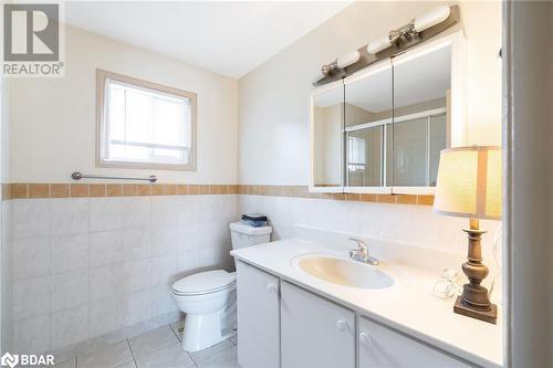 Bathroom with vanity, tile patterned flooring, toilet, tile walls, and a shower with shower door - 15 Oakington Place, Mississauga, ON - Indoor Photo Showing Bathroom