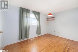 Spare room with wood-type flooring - 