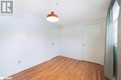 Unfurnished room featuring wood-type flooring - 